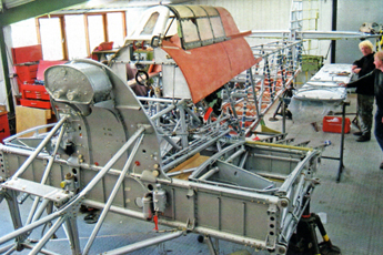 The partly restored Fuselage and Centre Section in March 2007. On the firewall is the coolant header tank.